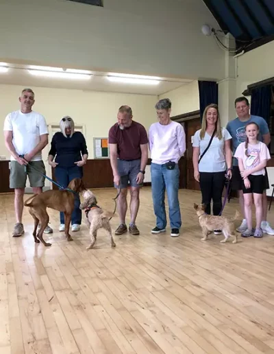 A group of dog owners from Horsham and Dorking, with their dogs, having just completed a dog training course.