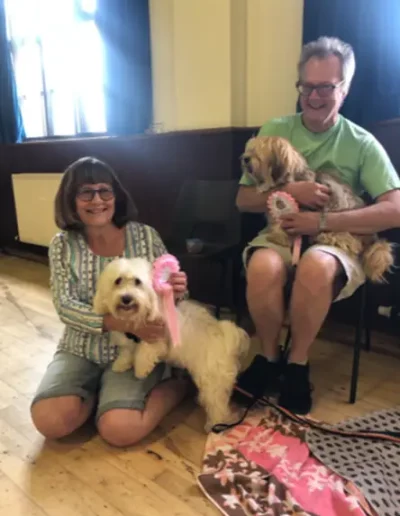 Dog owners with their dogs having completed a dog training course.