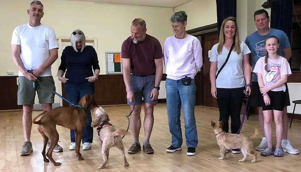 A group of dog owners from Horsham and Dorking, with their dogs, having just completed a dog training course.